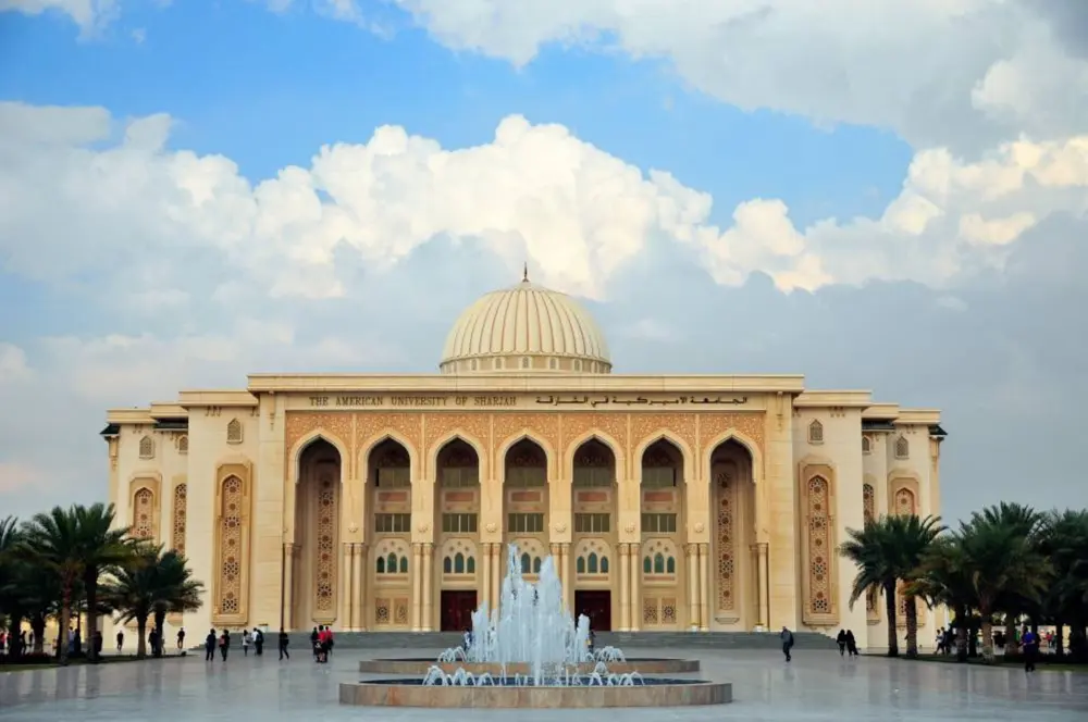 American University of Sharjah campus main building with Islamic architecture and fountain in front